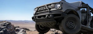 Close-up of Bronco front parked on rocky terrain