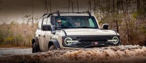 Front side view of 2022 Bronco driving in water