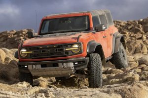 Front side view of Bronco driving over rocky terrain